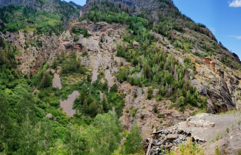 Overview of Silver Creek and Dunmore Mine (left-center), with foundation of Dunmore Mine tram tower (lower-right) alongside U.S. Highway 550 (photo by author, 2024).